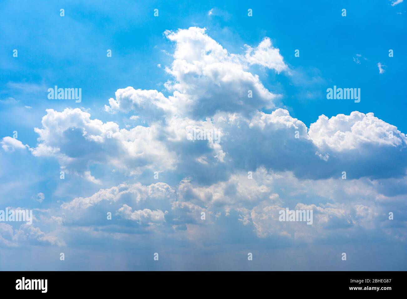 Cloudscape photo of white clouds on clear blue sky Stock Photo - Alamy