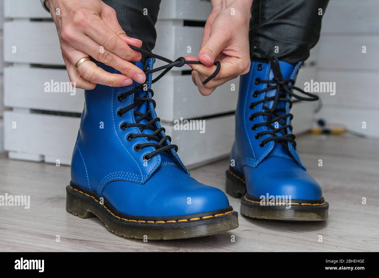 Oslonino, Poland 25th, April 2020 Woman laces her new pair of Dr. Martens  1460 Air Wair blue leather boots in Oslonino, Poland on 25 April 2020 ©  Vadim Pacajev / Alamy Live News Stock Photo - Alamy