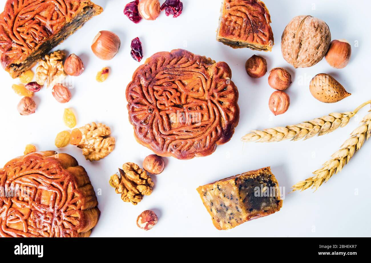 Traditional Chinese moon cakes and walnut raisin hazelnut isolated on