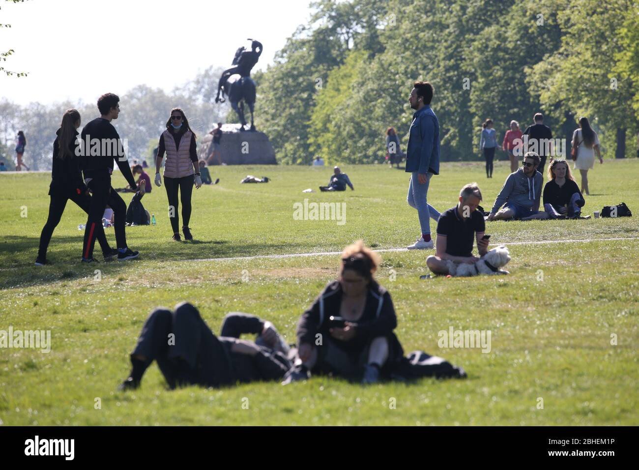 People walking and relaxing in Kensington Gardens, London, as the UK continues in lockdown to help curb the spread of the coronavirus. PA Photo. Picture date: Saturday April 25, 2020. See PA story HEALTH Coronavirus. Photo credit should read: Jonathan Brady/PA Wire Stock Photo