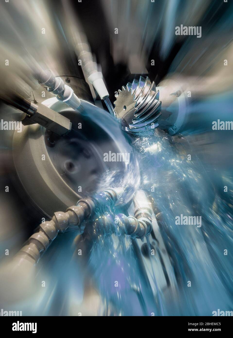 gear wheel is machined on a CNC grinding machine Stock Photo