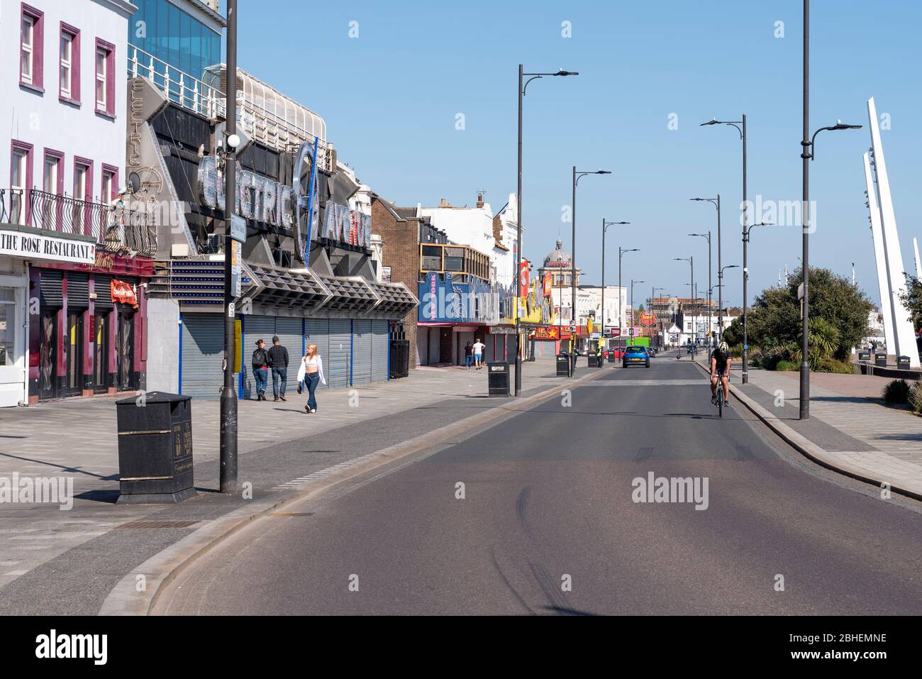 Southend on Sea, Essex, UK. 25th Apr, 2020. A few people are out enjoying the warm sunny weekend day in Southend on Sea but are largely obeying the request to stay home during the COVID-19 Coronavirus pandemic lockdown period. Those that are out are keeping to the social distancing guidelines Stock Photo
