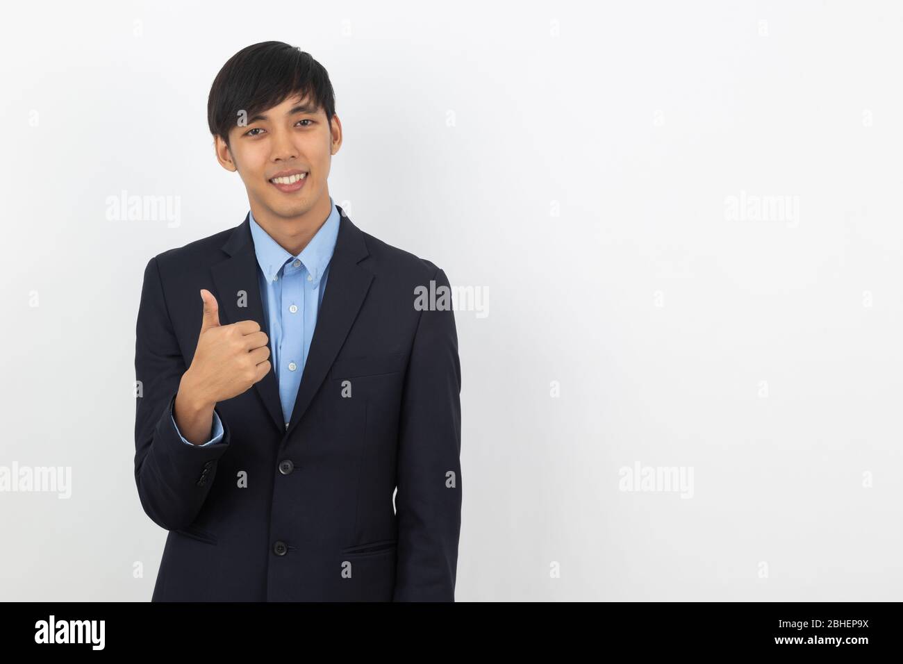 Young handsome asian business man smiling and showing thumbs up ...