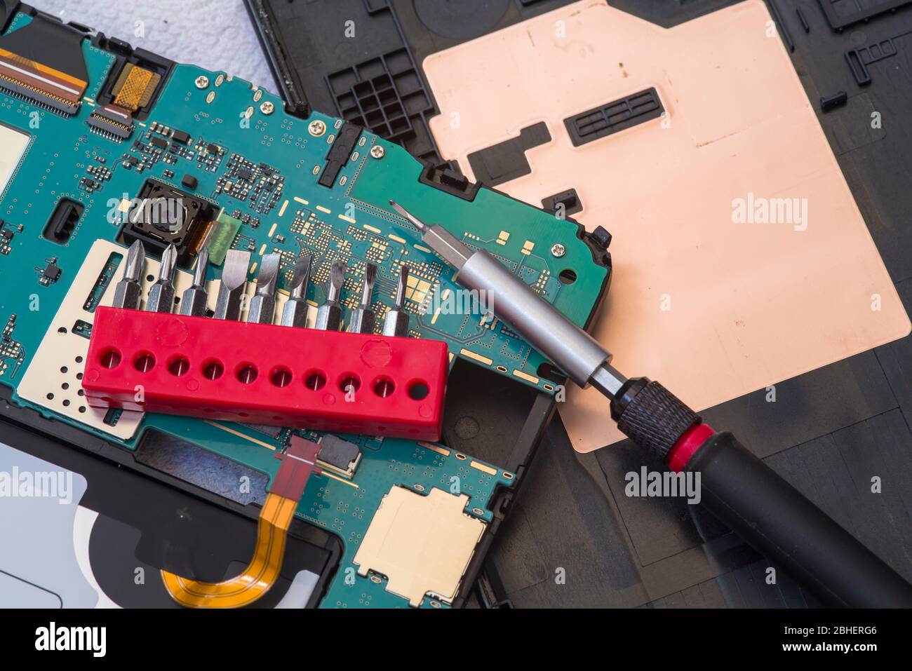 Close image of tablet repair process, screw set Stock Photo Alamy