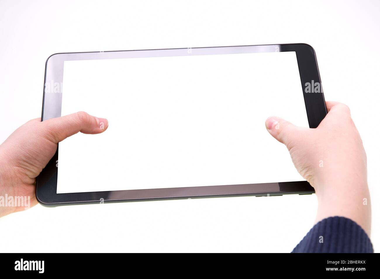 Tablet with white screen in boy hands over a white background Stock Photo