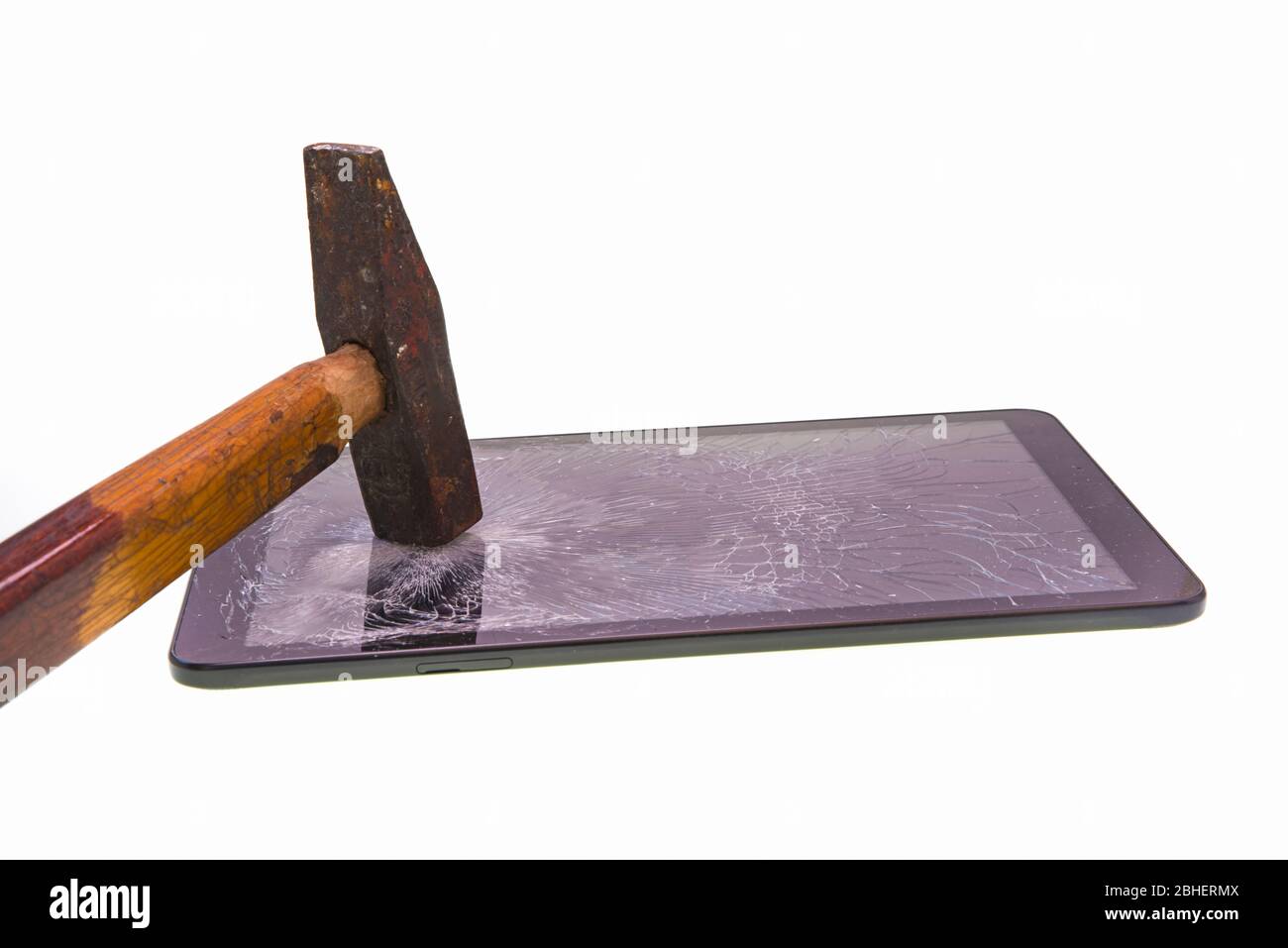 Broken screen tablet with a hammer over white Stock Photo