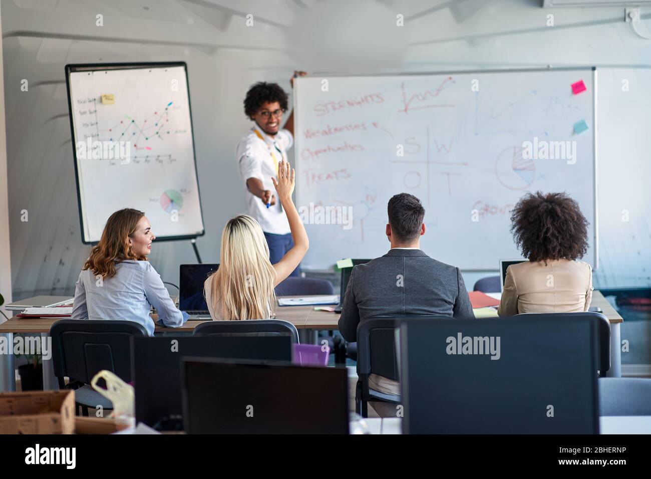 young afro-american male manager teaching colleagues about SWOT analysis. business lecture, presentation Stock Photo