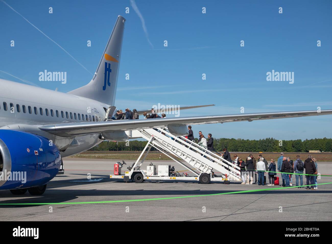 Travelers entering an airplane ready for departure at Eindhoven airport Stock Photo