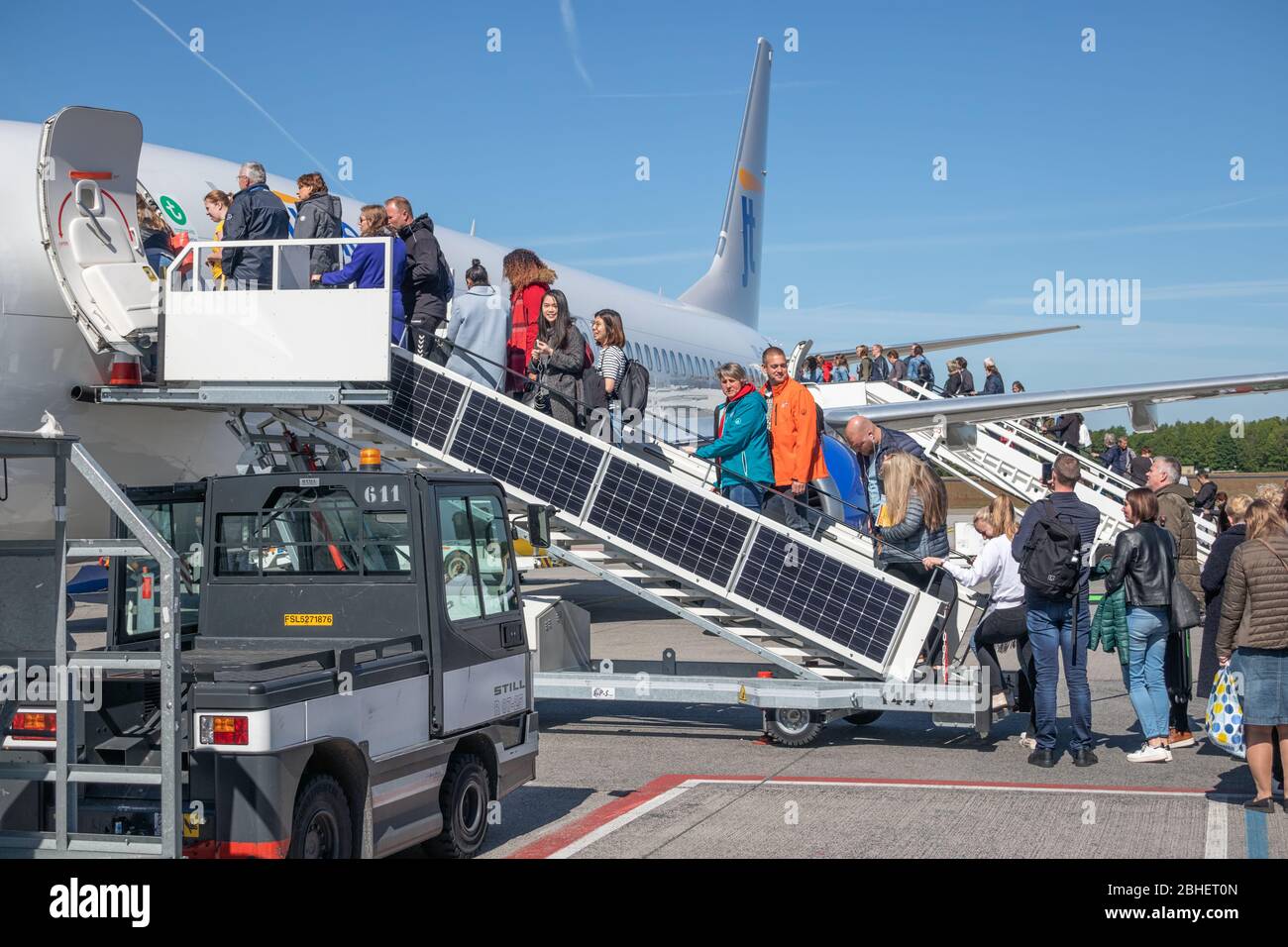 Travelers entering an airplane ready for departure at Eindhoven airport Stock Photo