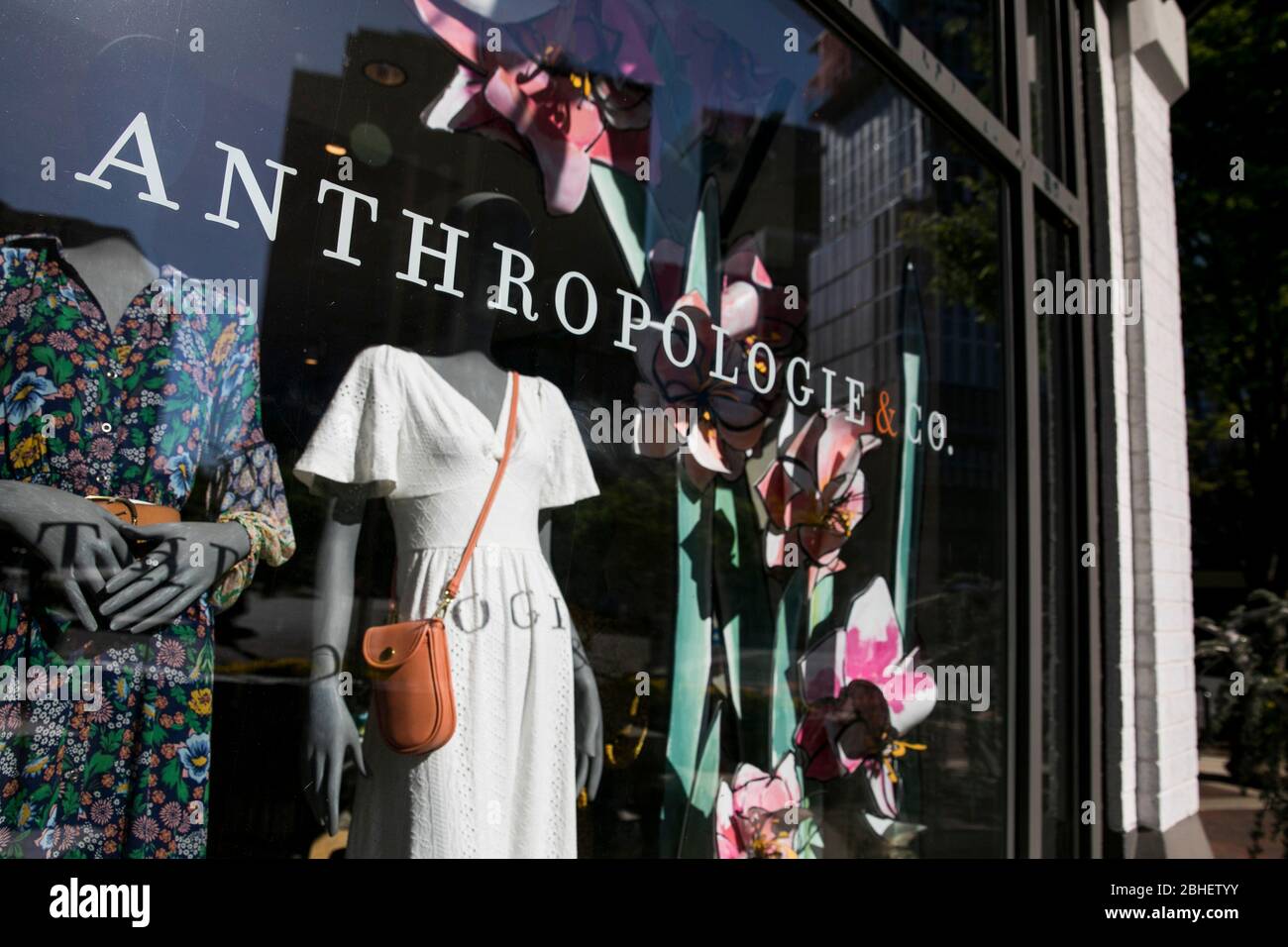 A logo sign outside of a Anthropologie & Co., retail store location in
