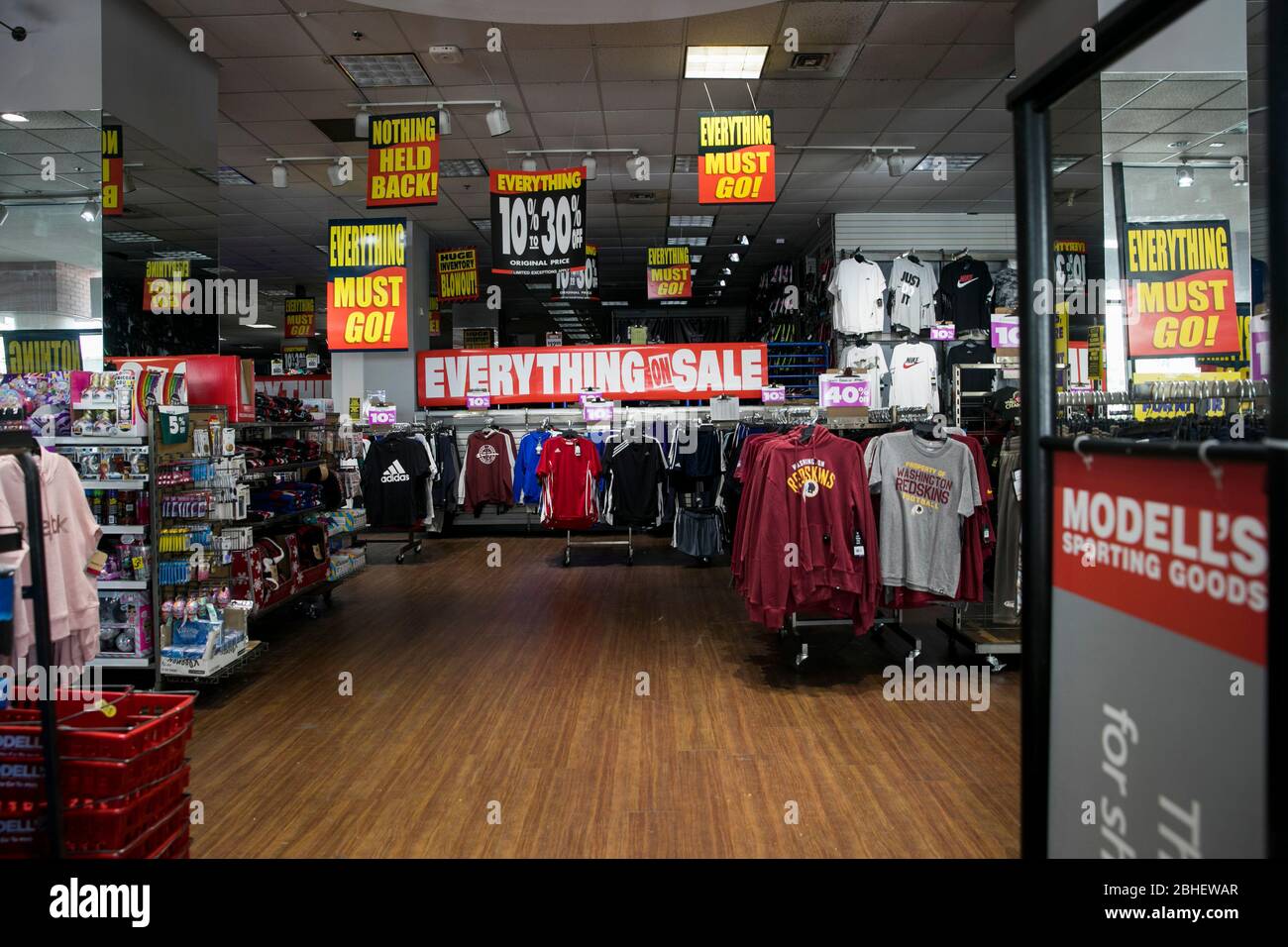 'Everything Must Go' signage inside a Modell's Sporting Goods retail that is being liquidated store location in Bethesda, Maryland on April 22, 2020. Stock Photo