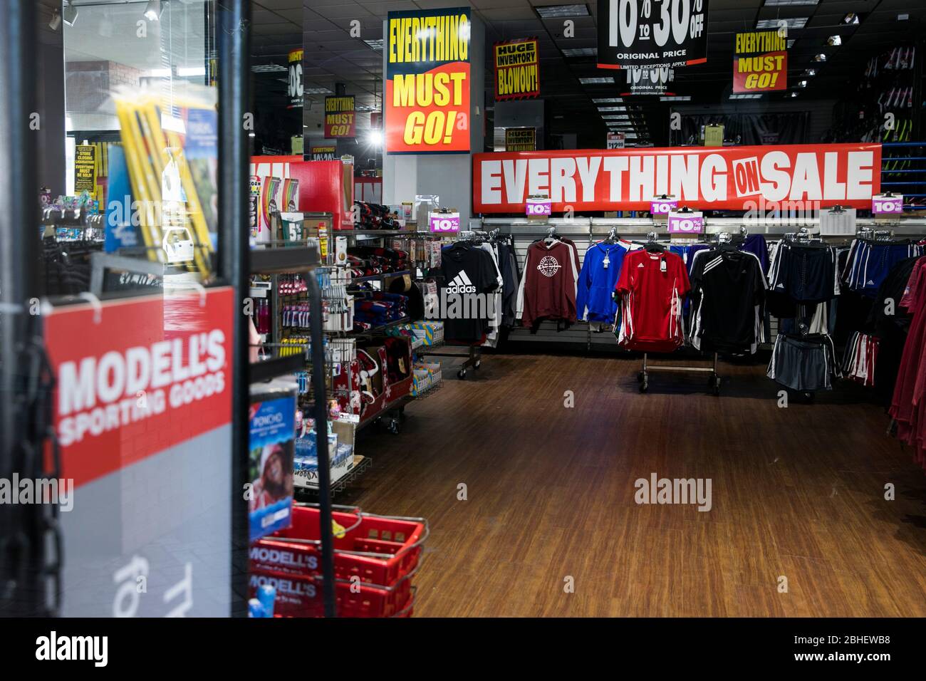 'Everything Must Go' signage inside a Modell's Sporting Goods retail that is being liquidated store location in Bethesda, Maryland on April 22, 2020. Stock Photo