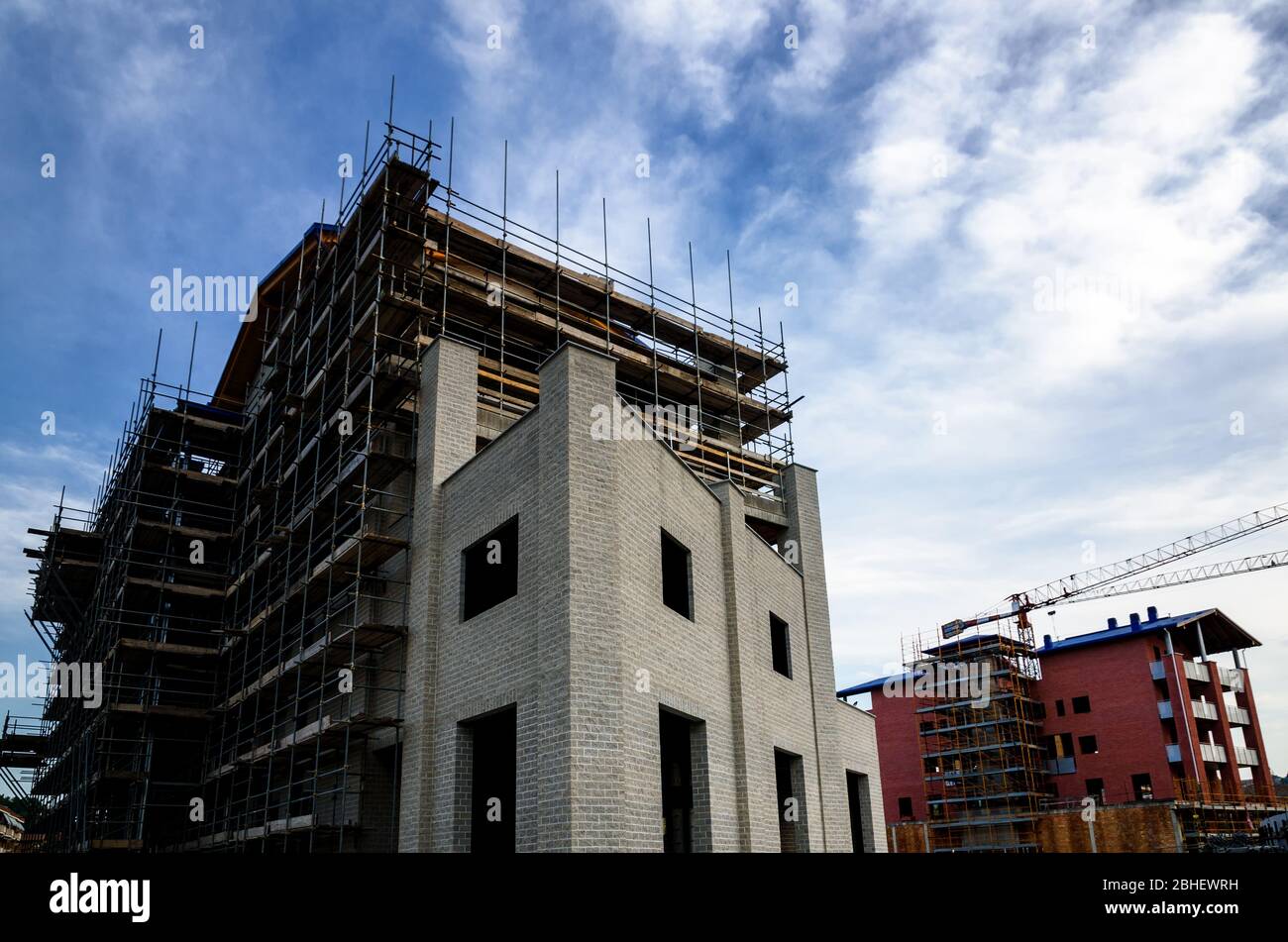 Building construction work yard with crane and clouds Stock Photo