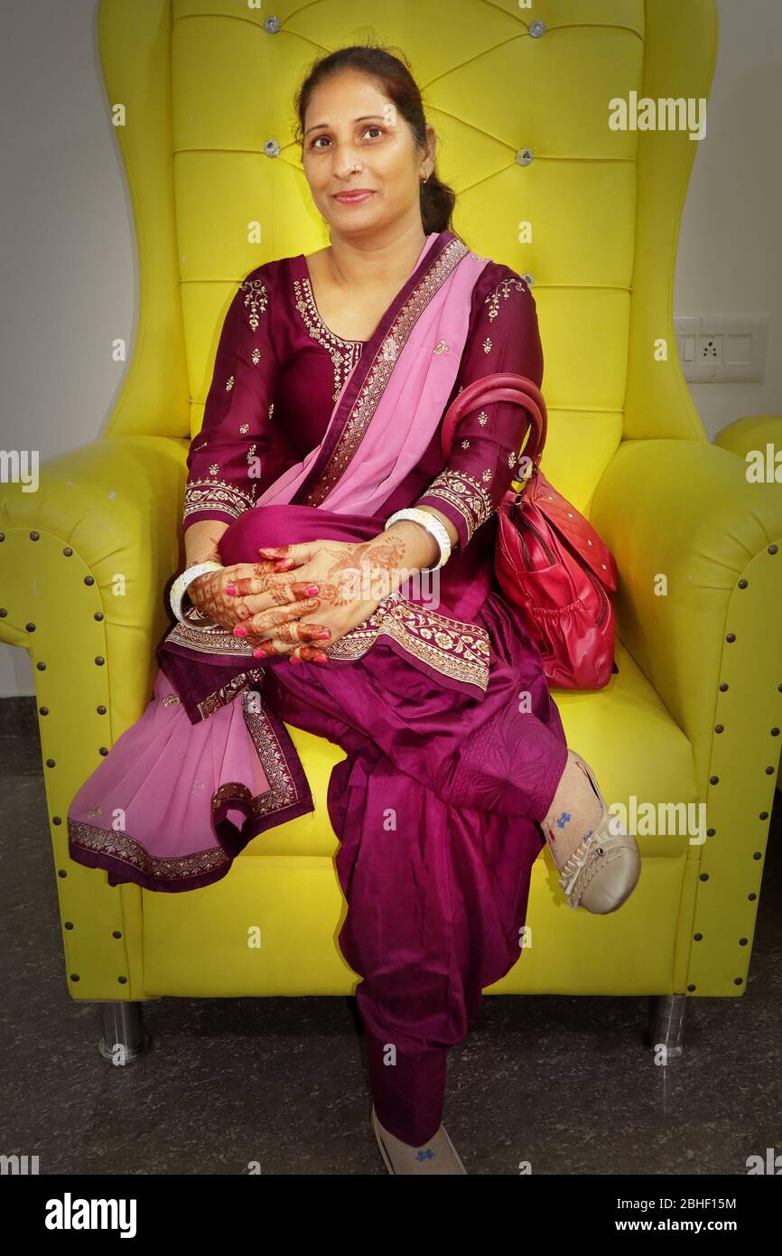 Mature Indian women relaxing on luxury sofa at home. Close up lady relaxing at home Stock Photo
