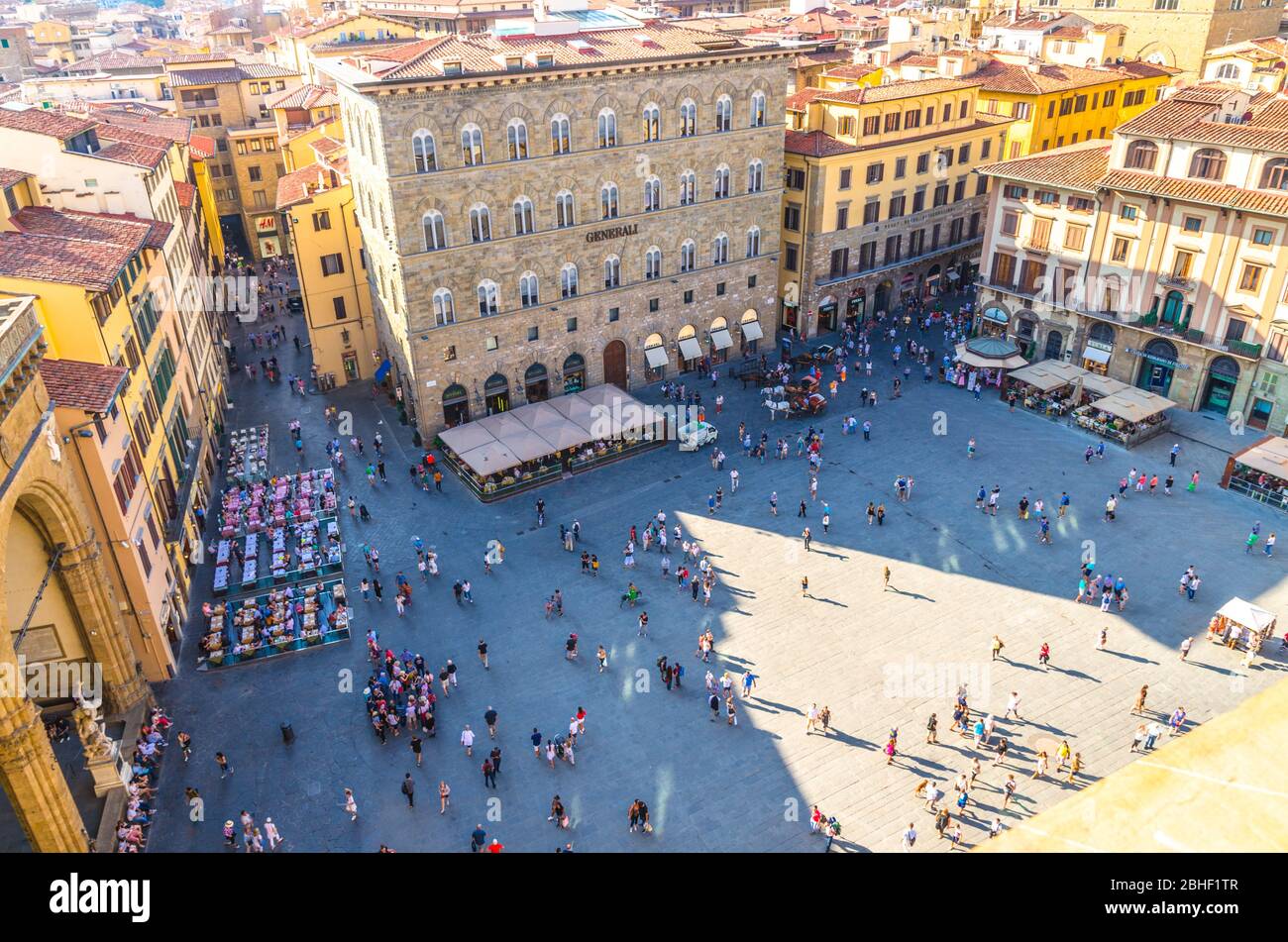 Florence, Italy, September 15, 2018: Crowd of small figures of people are walking on Piazza della Signoria square in historical centre, top view from Palazzo Vecchio palace Stock Photo