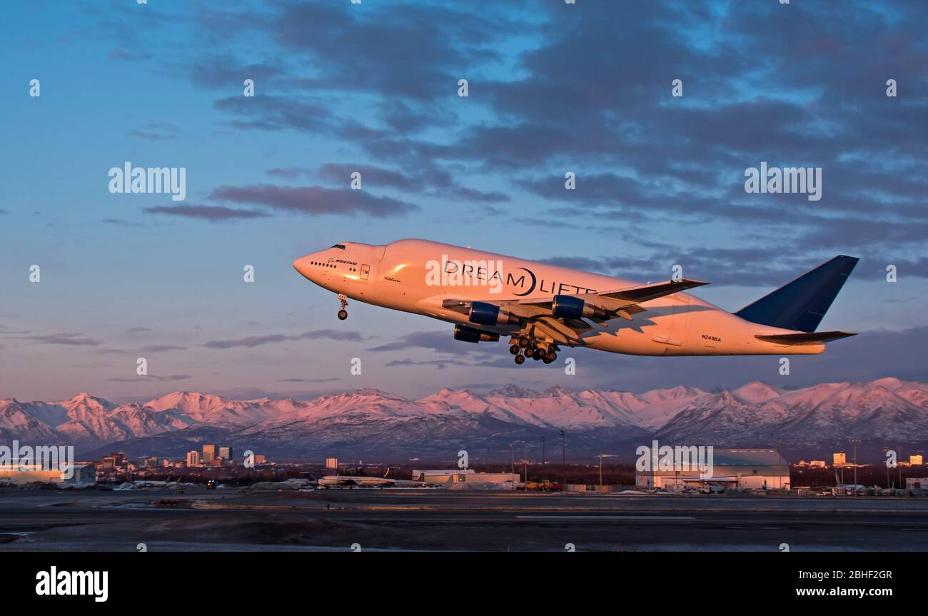 A Boeing Dreamlifter takes off from the Ted Stevens Anchorage International Airport at sunset Stock Photo