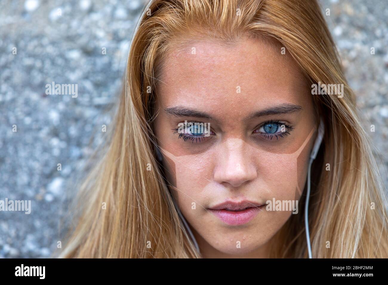 beautiful young woman with tan lines caused by a surgical mask maybe used under lockdown or social distancing for coronavirus COVID19 or another disea Stock Photo