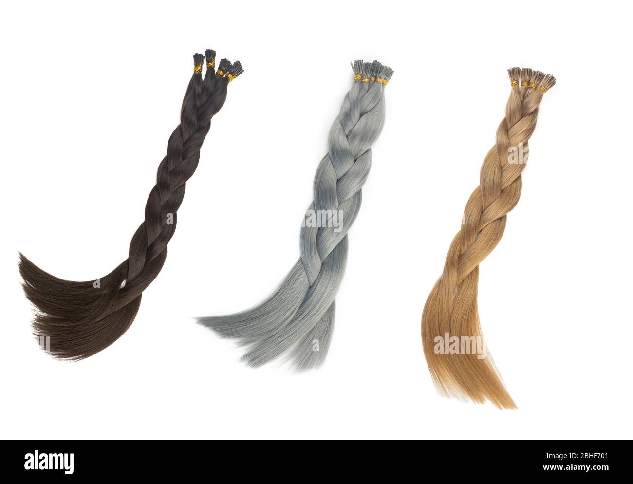 Set of multiple fake women hair extensions in tails, isolated on white background. Dark blonde, brown and silver color. and different attachment types Stock Photo