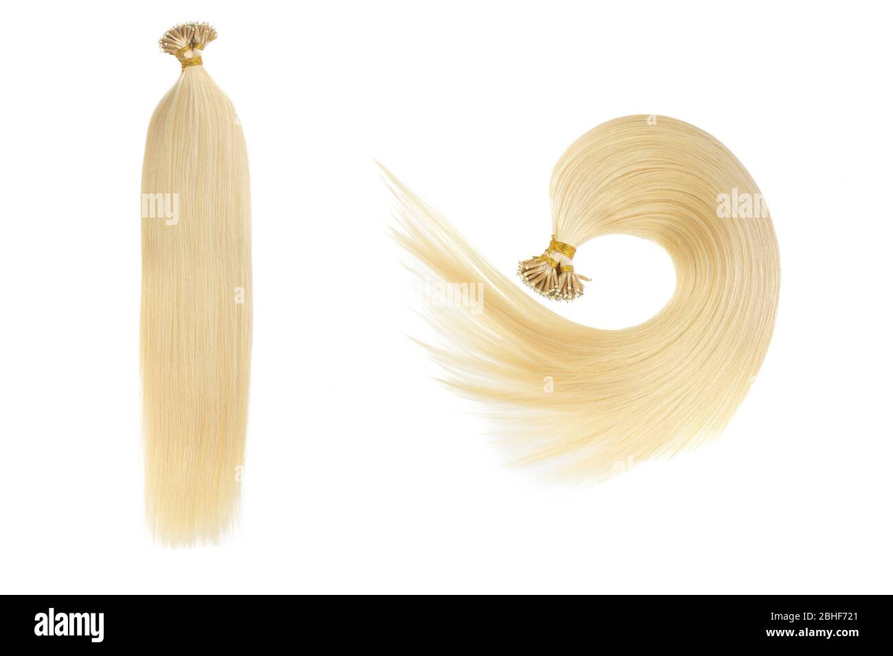 Set of two fake women hair extensions in tails, isolated on white background. Light blonde or gold color. Stock Photo