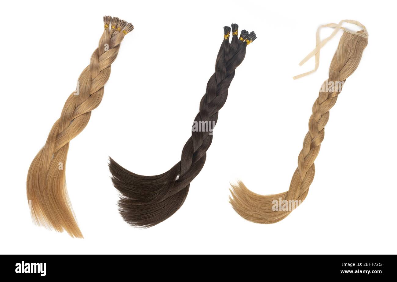 Set of multiple fake women hair extensions in tails, isolated on white background. Dark blonde and brown color. and different attachment types. Stock Photo