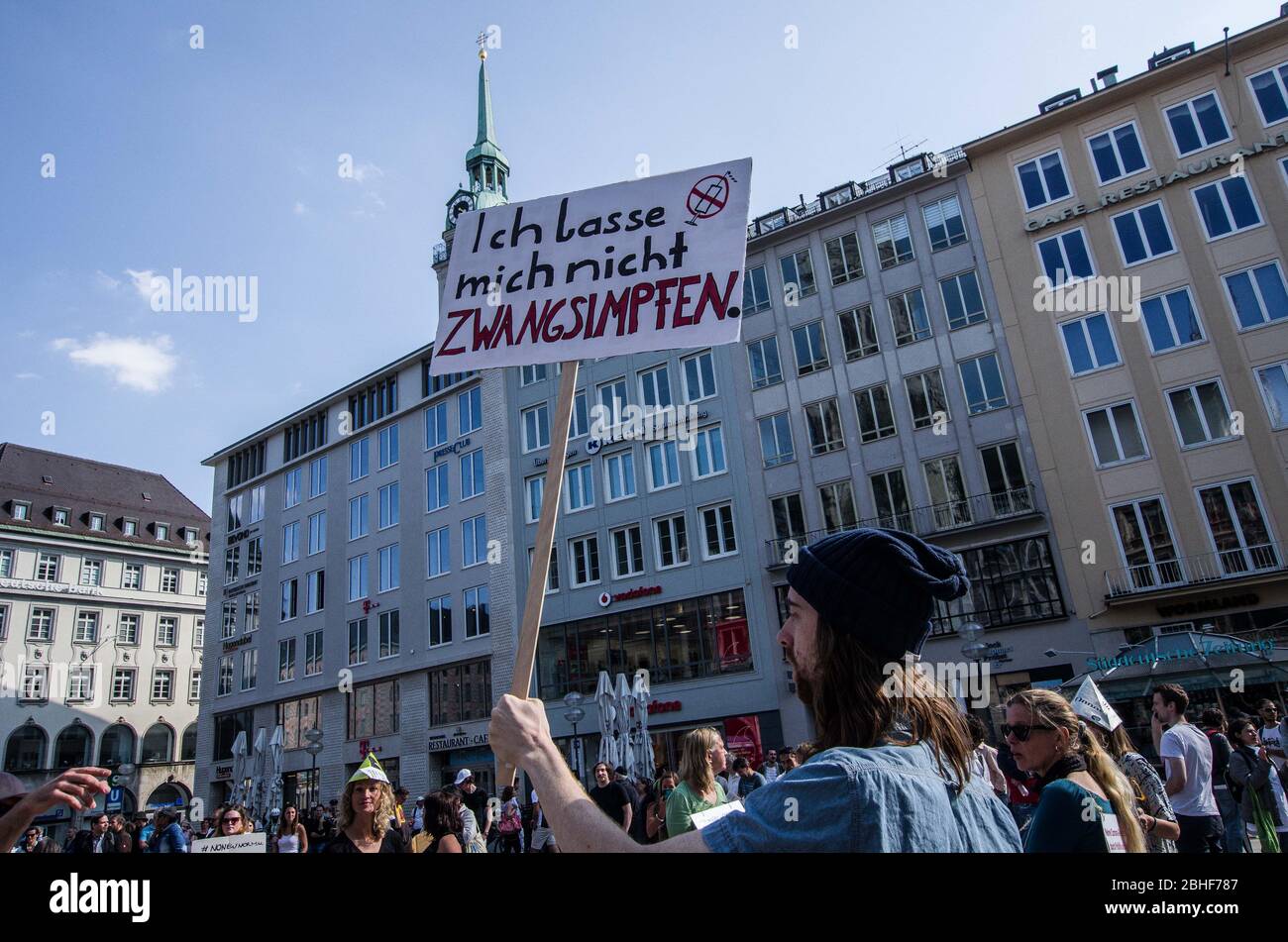 Munich, Bavaria, Germany. 25th Apr, 2020. An anti-vaxxer displays a sign opposing vaccines at a QAnon-like demo in Munich, Germany. Organized in Telegram chats by conspiratorial 'Querfront'' (cross-front) groups, the city of Munich, Germany saw numerous anti-state 'Corona Parties'' as under mottos such as 'Demonstration fuer die Erhaltung der Grundrechte'' (Demonstration for the Upholding of Basic Rights) and 'Fuer unsere Freiheit, unsere Grundrechte und unsere Selbstbestimmung'' (Demonstration for our Freedom, Basic Rights, and Self-Determination). Numerous right-extremists, Ver Stock Photo