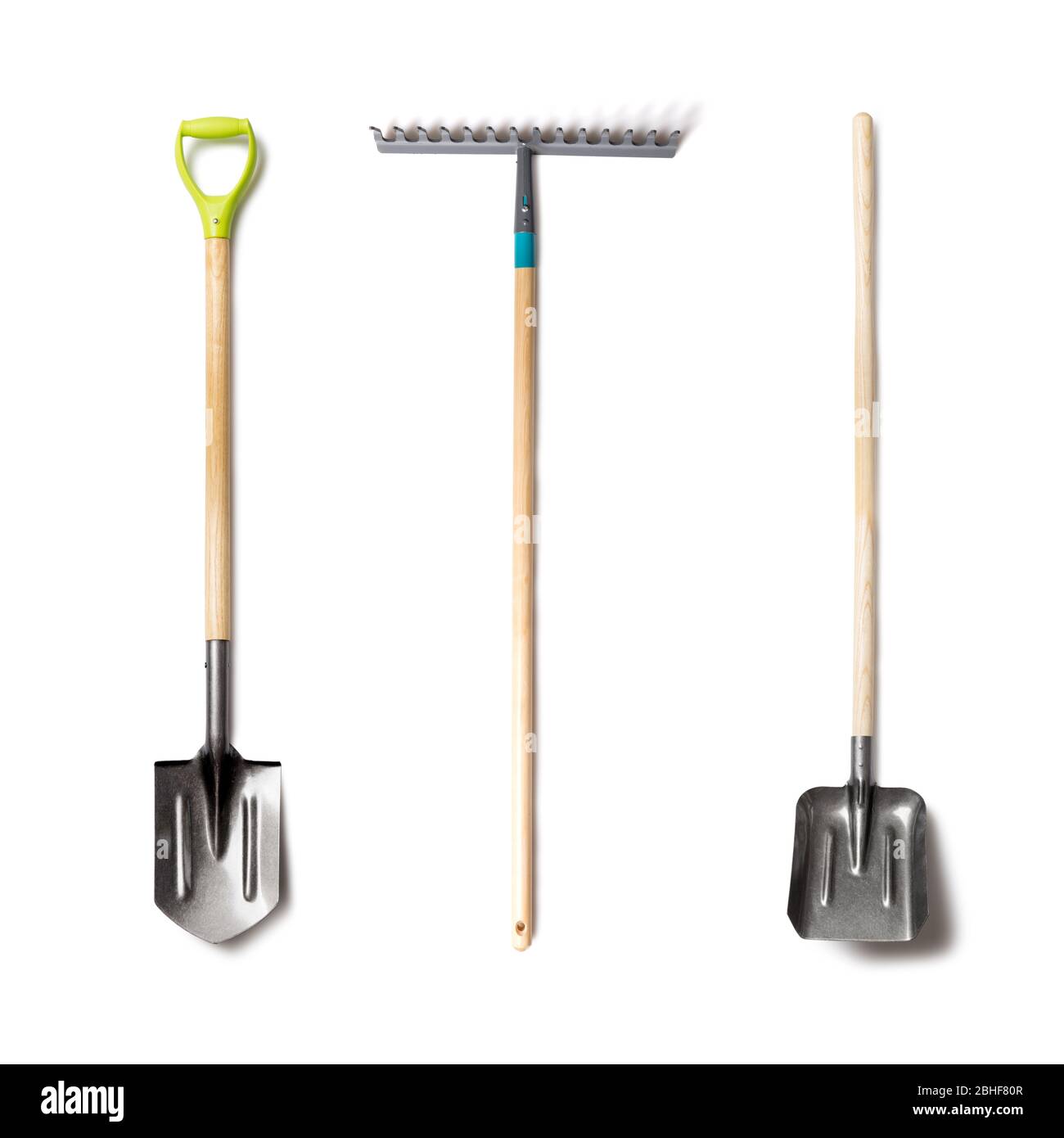 Set of garden tolls isolated. Spade shovel, rake and shovel with wood handle on white background Stock Photo