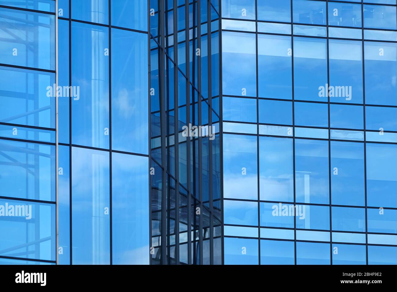 Blue windows of skyscraper. A fragment of a glass facade of a modern office building in a business district of a city. Rectangular windows Stock Photo