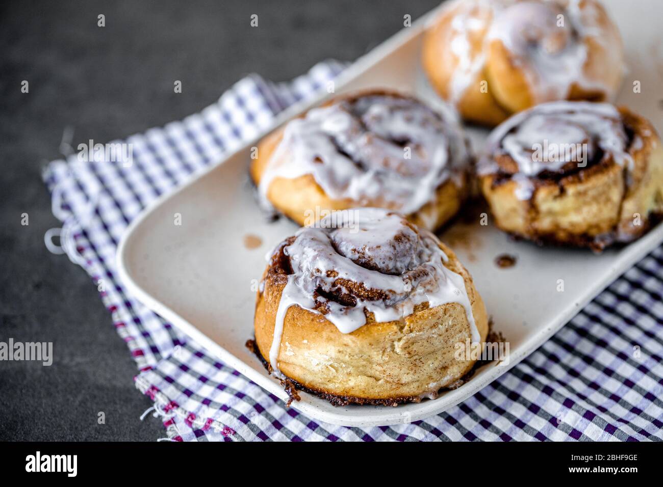 Fresh Homemade Cinnamon Rolls made on a plate with a napkin for breakfast Stock Photo