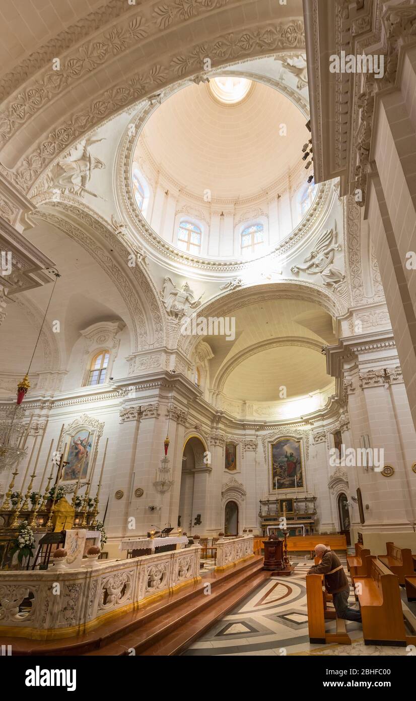 Man praying in The Sanctuary of Our Lady of Mellieha, Mellieha, Malta Stock Photo
