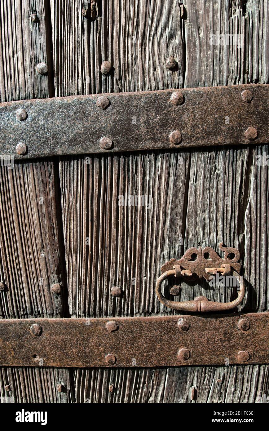 Old wooden door with rusted wrought iron fittings, Mallorca, Balearics, Spain Stock Photo