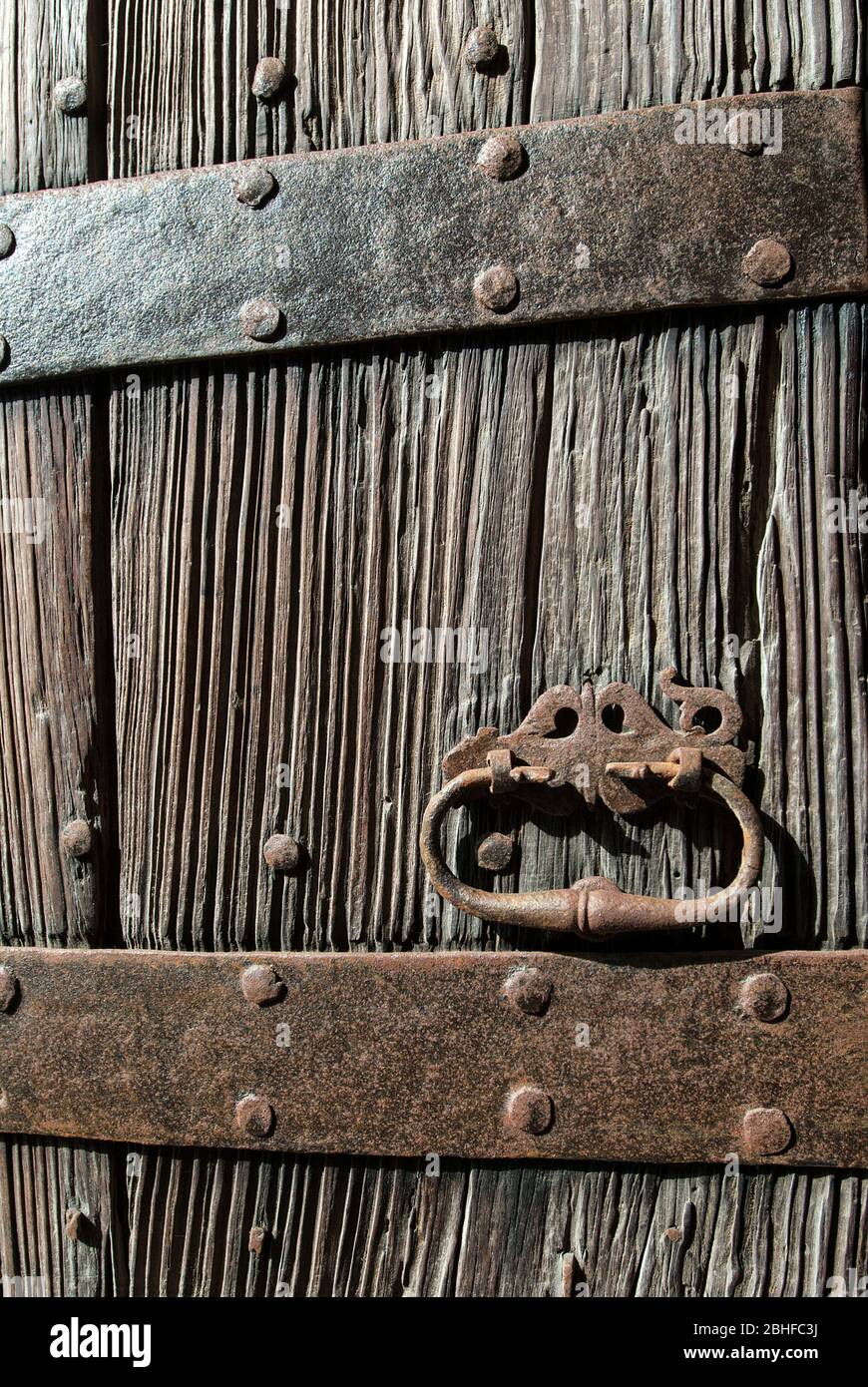 Old wooden door with rusted wrought iron fittings, Mallorca, Balearics, Spain Stock Photo