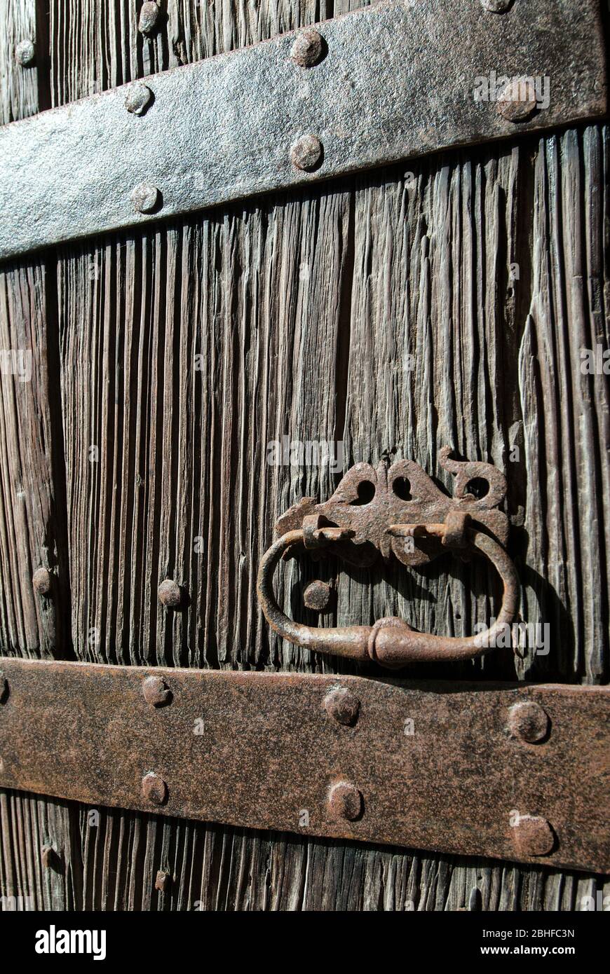 Old wooden door with rusted wrought iron fittings, Mallorca, Balearics, Spain Stock Photo