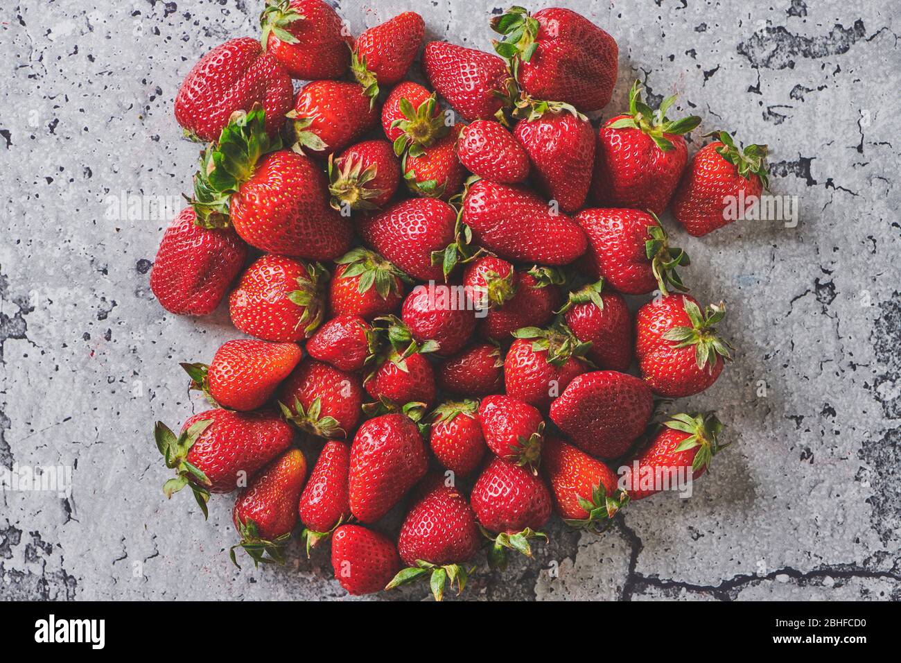 Fresh strawberry background on a cement texture Stock Photo - Alamy