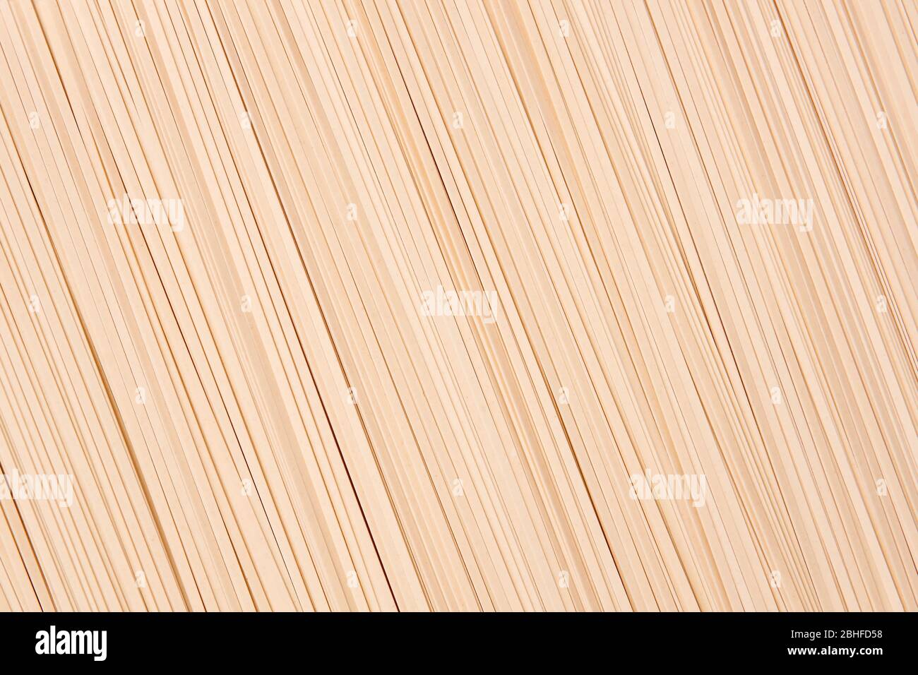 background of dry uncooked udon, thin noodles made from wheat flour