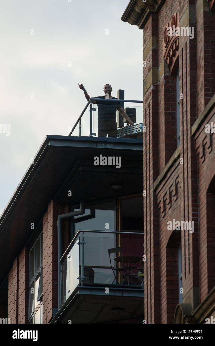 MANCHESTER, UK The Ancoats district of Manchester comes to a standstill as DJ Coast2Coast puts on a short DJ set on the top of one of the residential buildings. He is raising funds for The Samaritans and Cyclists Fighting Cancer. Saturday 25th April 2020. (Credit: Pat Scaasi | MI News) Credit: MI News & Sport /Alamy Live News Stock Photo