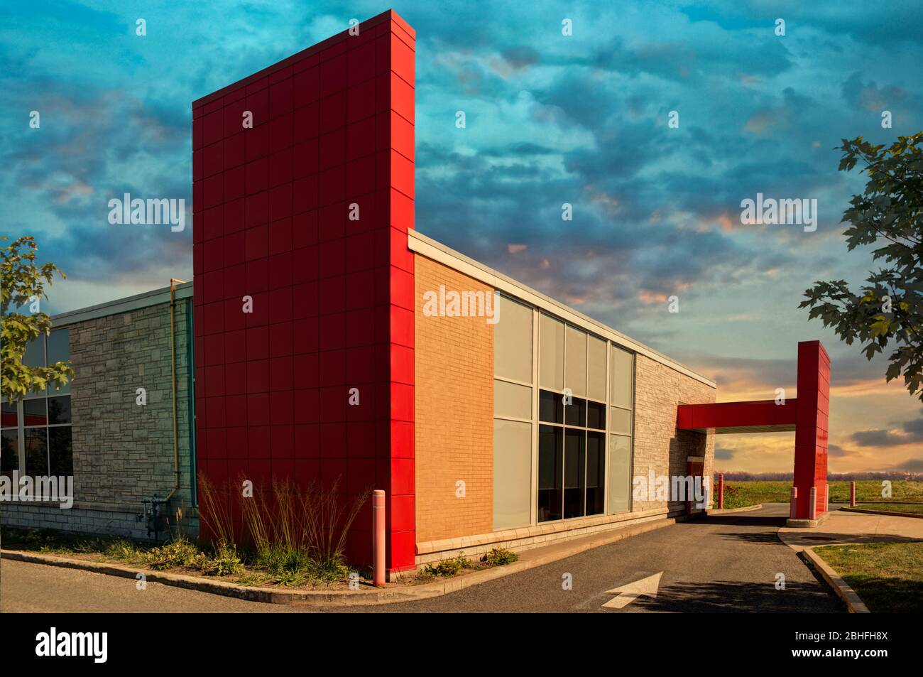 Bank drive thru on a summer day, cloudy sky in background. Stock Photo