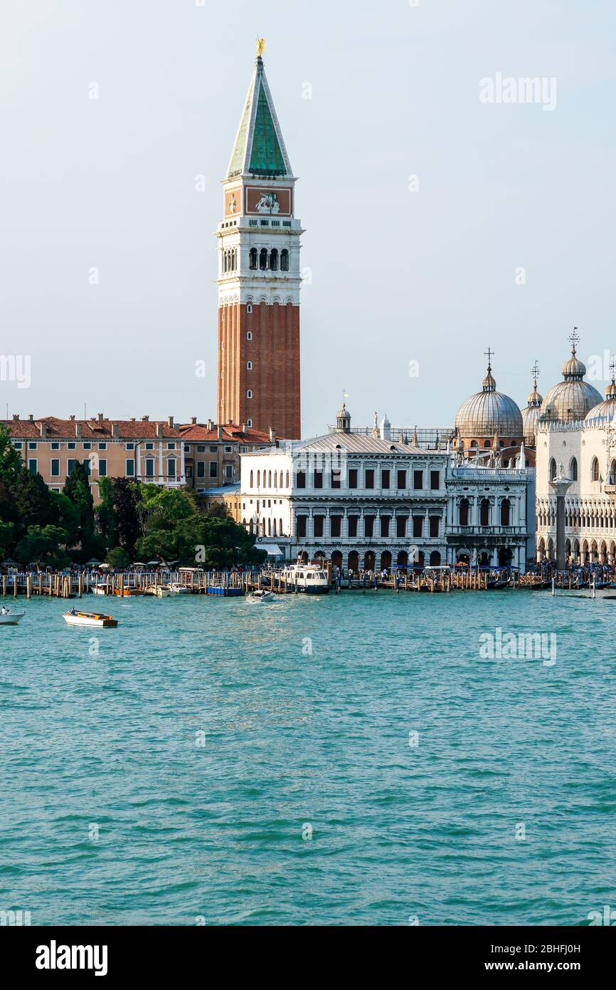 Campanile or bell tower of St Marks Cathedral, Piazza San Marco. Saint Mark's Square. People crowd the public dock area on the Grand Canal. Stock Photo