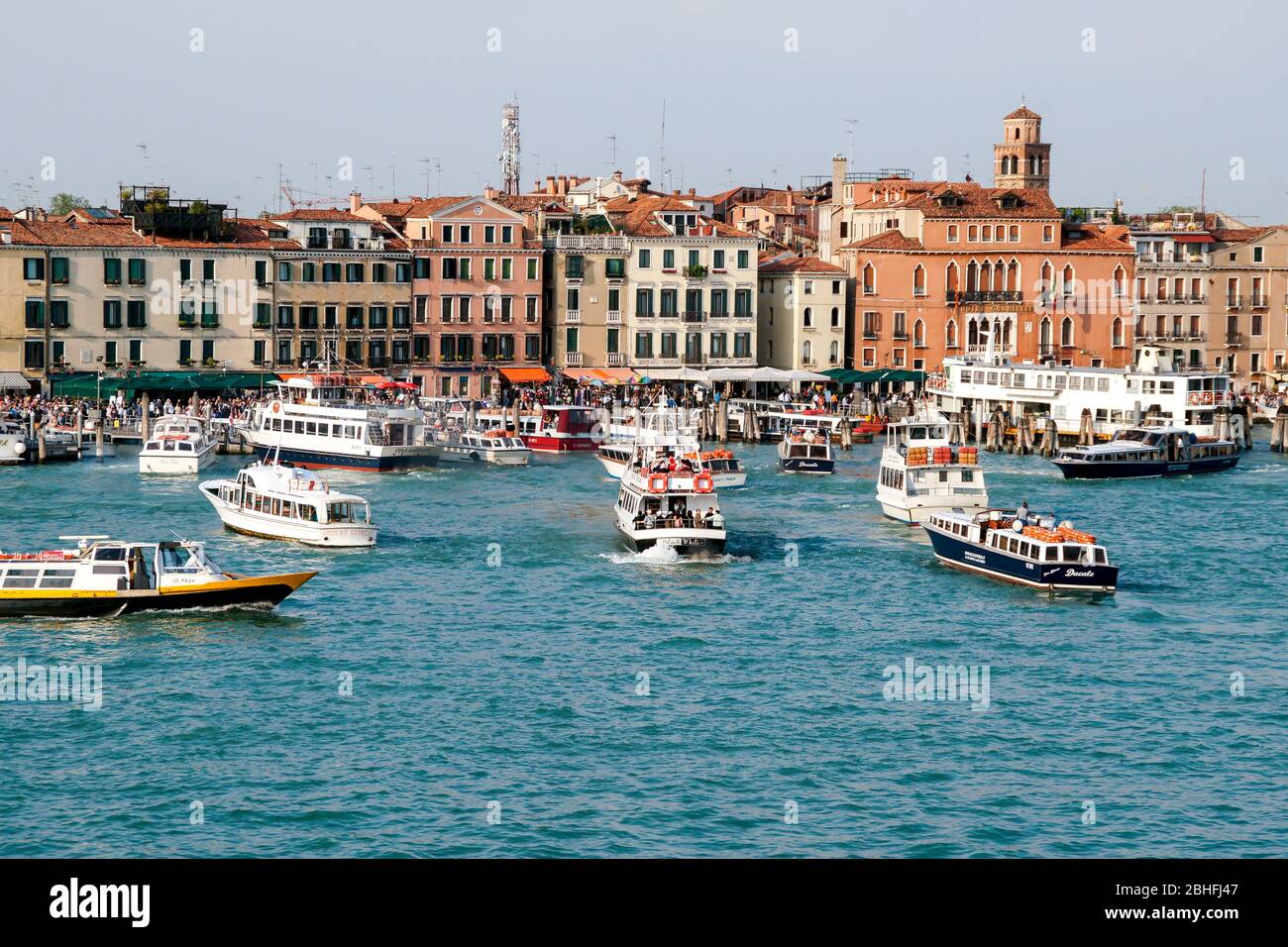 Public transportation and tourist boats waiting to dock at the public marina. Late afternoon. Venice Italy Stock Photo