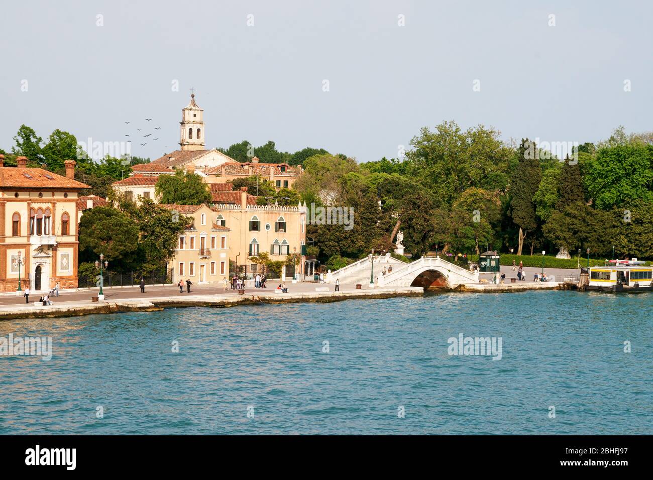 From the Grand Canal looking toward the Park of Remembrance -Parco delle Rimembranze. A typical arched bridge over the entry to a small residential ar Stock Photo