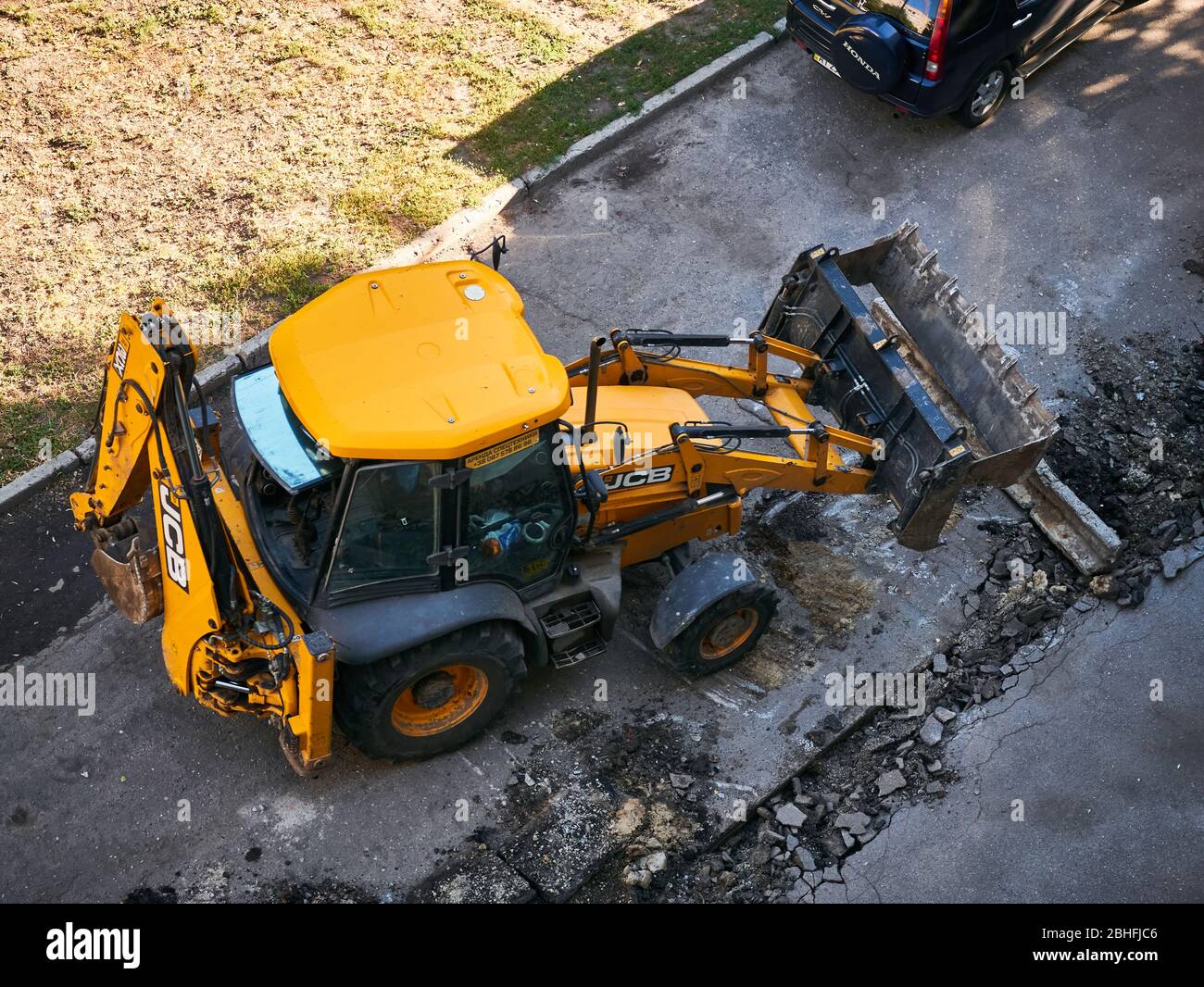 Hydraulic Excavator Removing Remains of asphalt. Road reconstruction