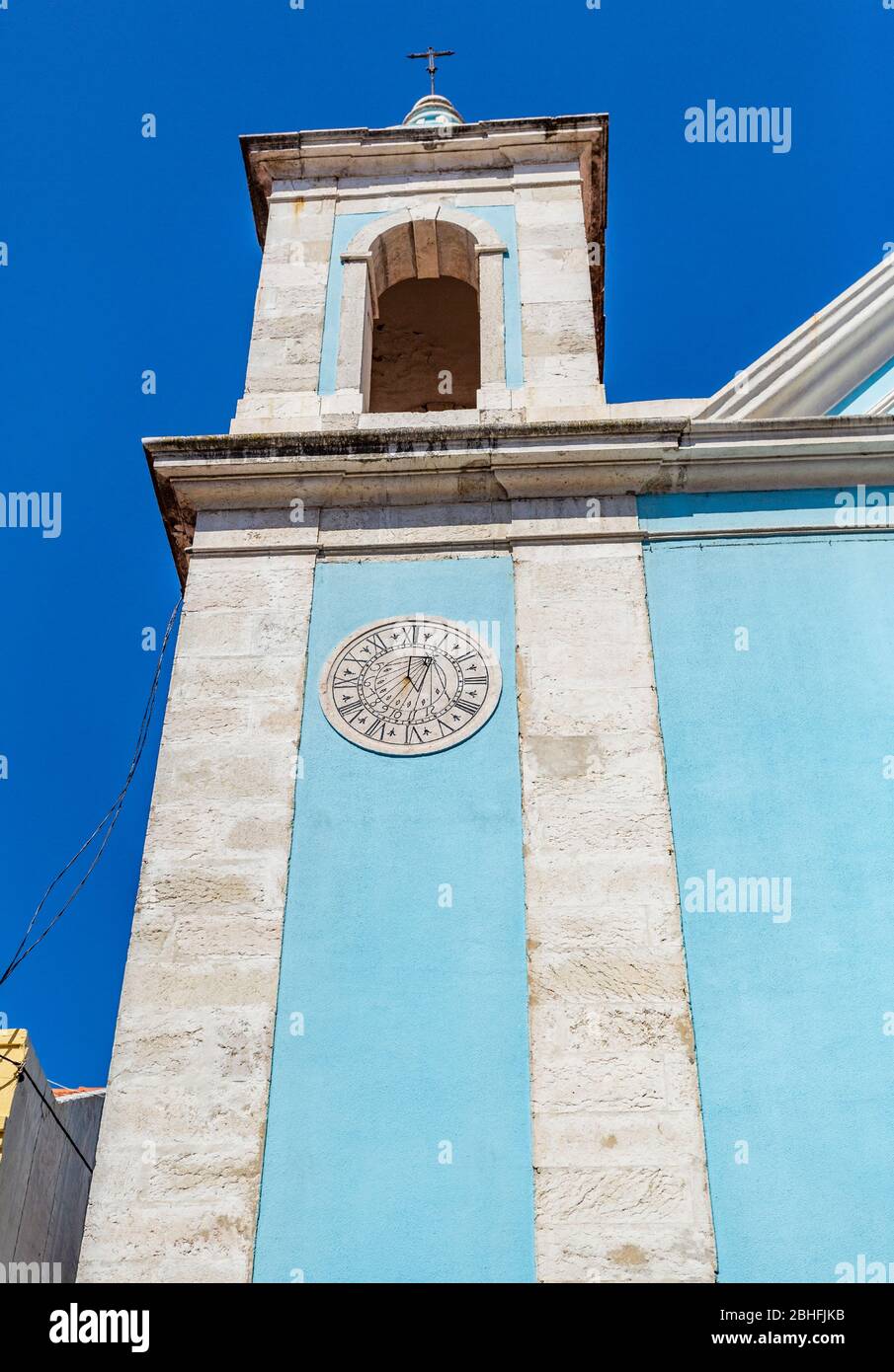 Detail of the west bell tower of the Church of Our Lady of Good Success, with its sundial (sun clock), in Cacilhas, Portugal, Stock Photo