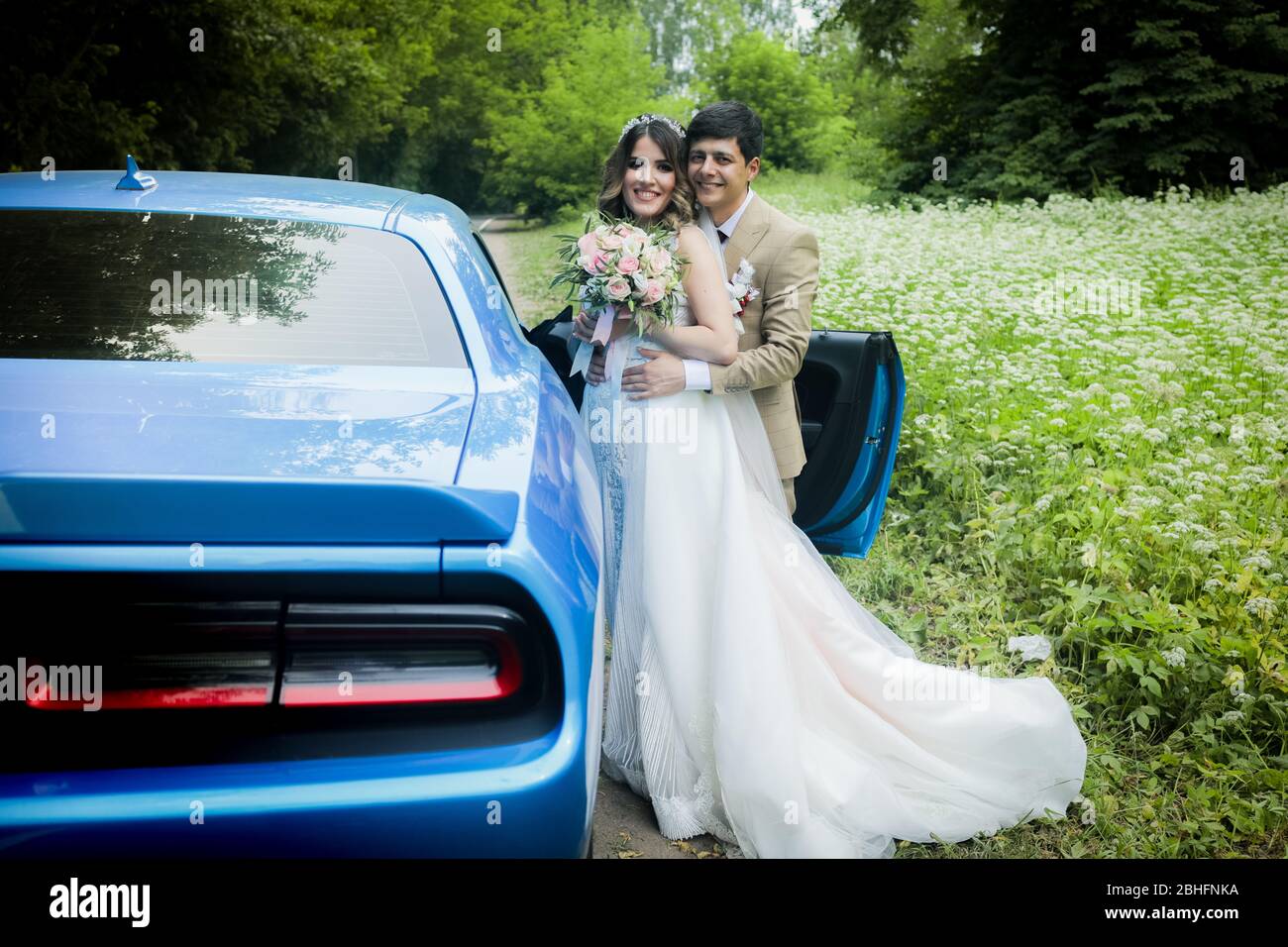 The bride and groom in a beautiful respectable wedding car Stock Photo ...