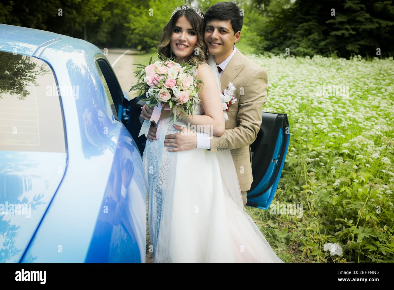 The bride and groom in a beautiful respectable wedding car Stock Photo ...