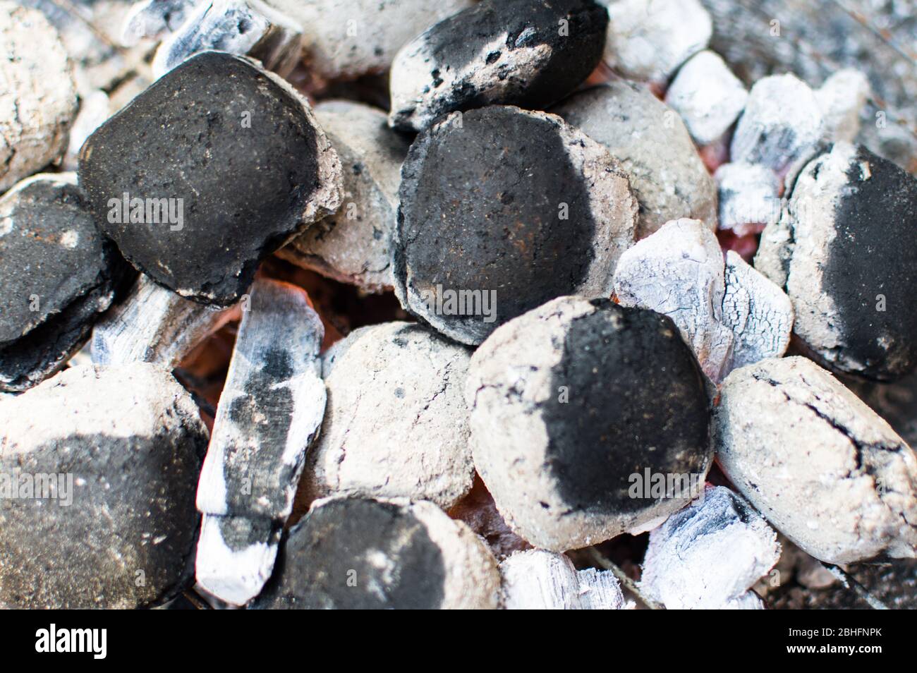 Lump wood briquettes burning in a small barbecue fire pit Stock Photo