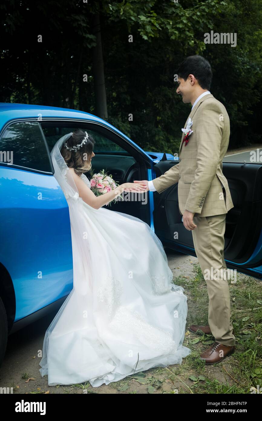 The bride and groom in a beautiful respectable wedding car Stock Photo ...
