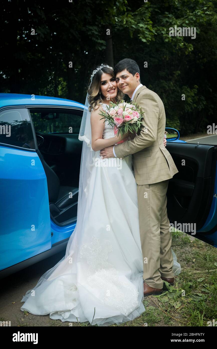 The bride and groom in a beautiful respectable wedding car Stock Photo ...