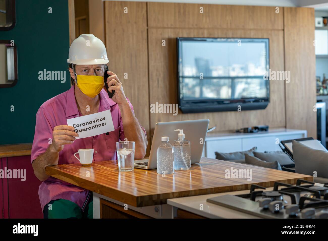 Concept of coronavirus quarantine. Man with a medical face mask using the phone to search for a Job. Stock Photo