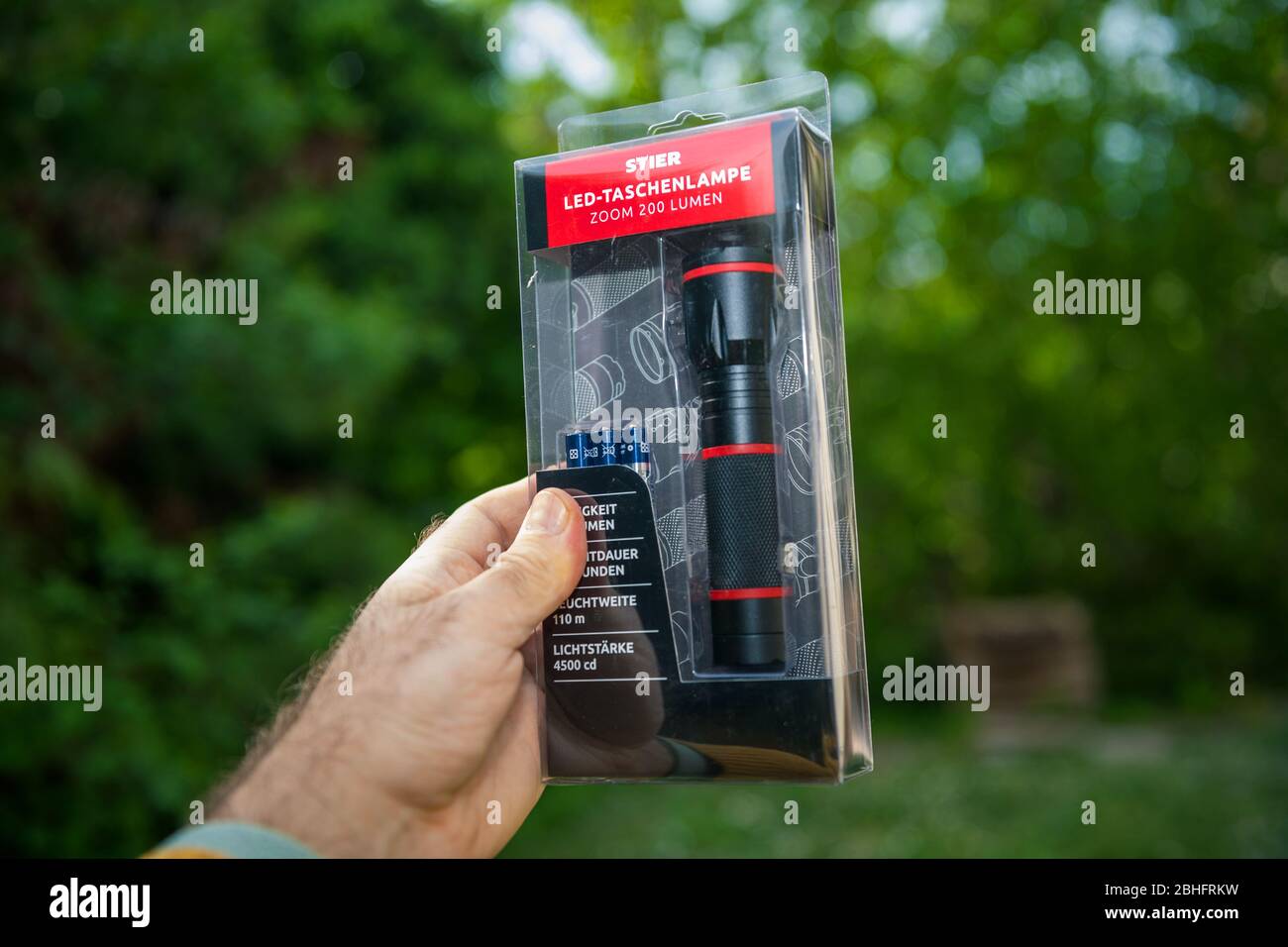 Cirkel Bang om te sterven methaan Paris, France - Apr 24, 2020: POV male hand holding new mini LED Stier  flashlight torch green forest background - STIER Werkzeuge is a German tool  man Stock Photo - Alamy