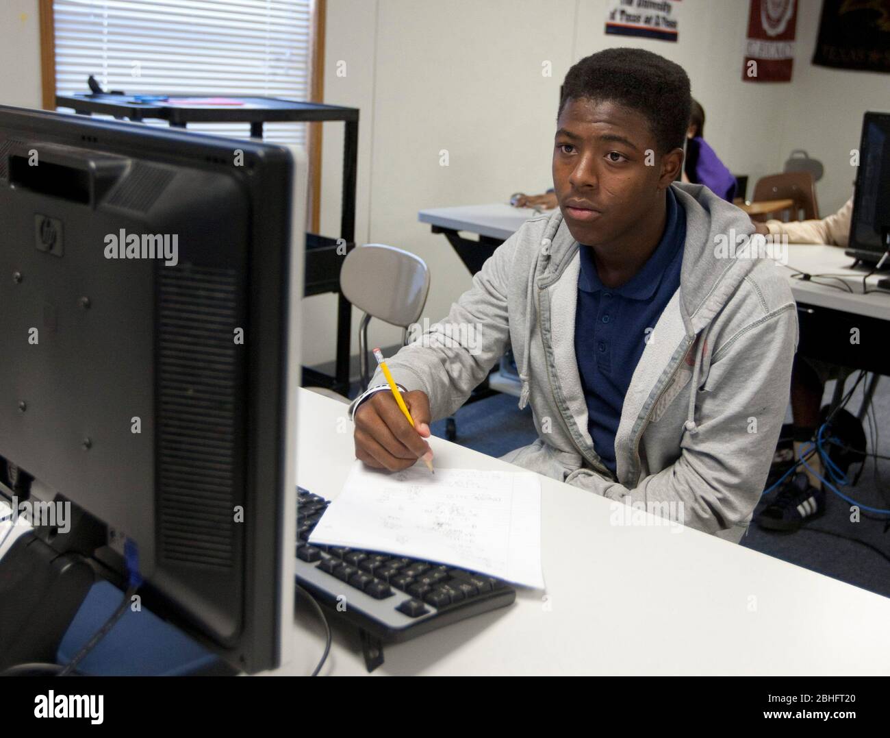 Houston, Texas June 2012 AfricanAmerican male student takes notes in computer lab at a public