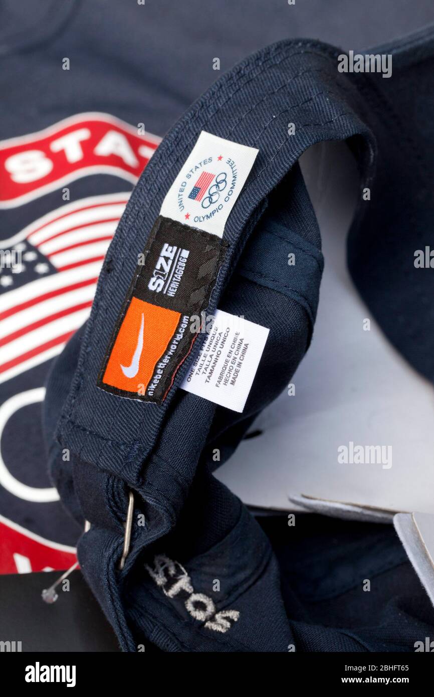 A 'Made in China' label and a U.S. Olympic Committee label adorn a United States Olympic Team-issued hat that was distributed to U.S. athletes and media in Dallas in May. In the background is a U.S. Olympic Team t-shirt that has a 'Made in Indonesia' label. ©Bob Daemmrich Stock Photo